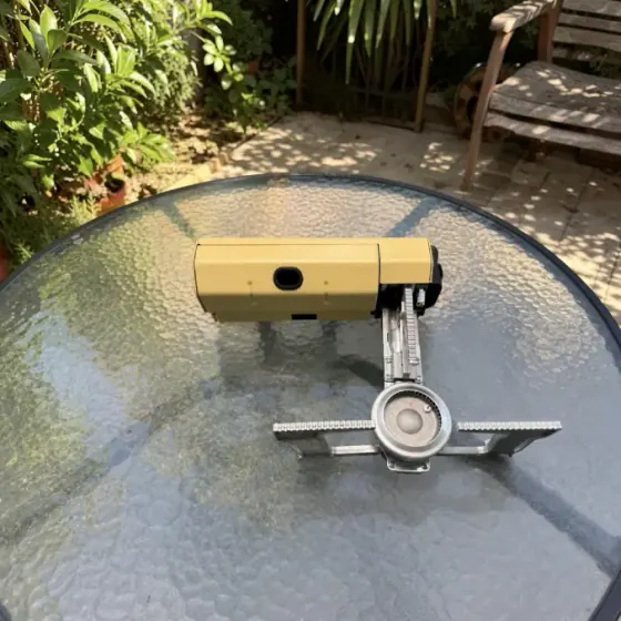 Qinux GoFlamex set up on a backyard patio table for a cookout